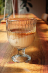 Coffee latte macchiato in glass on wooden table