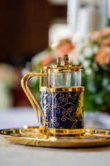 golden teapot on the table in a wedding ceremony.