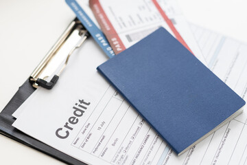 Credit cards with airline tickets for vacations on laptop background