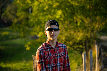 Teenage boy in green nature waiting for magic. Inquisitive childhood.