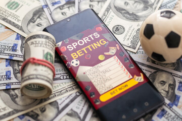 Fototapeta premium inscription your bet wins on a smartphone on the poker table. Bets, sports betting, bookmaker. Mixed media.