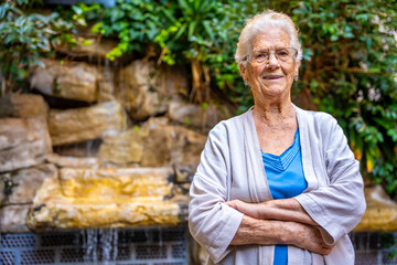 Elder woman looking at camera outdoors in a geriatric