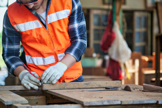 Focus on meaturement of capenter in wood studio for craft ferniture.