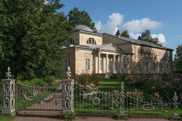 Fototapeta na wymiar View of the Pavilion of Roses (Pink Pavilion) in Pavlovsky Park — landscape park as part of the Pavlovsk State Museum-Reserve on a sunny summer day, St. Petersburg, Russia