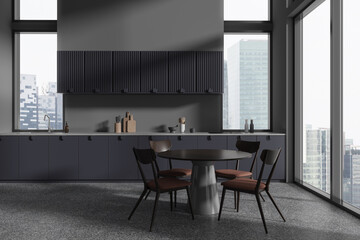 Gray and blue kitchen interior with round dining table