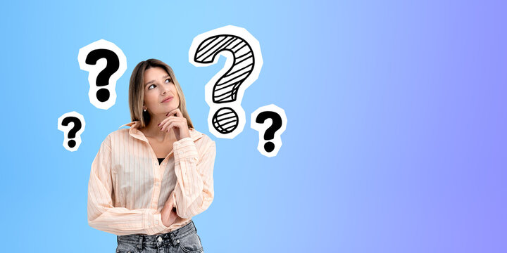 Pensive young woman smiling and looking up at question marks, copy space
