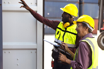 Japanese engineer with black man worker open container at shipping logistic port