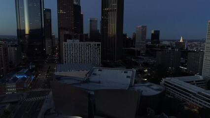Aerial Tilt Up Shot Of Walt Disney Concert Hall Near Streets In Downtown Against Sky At Dusk - Los Angeles, California