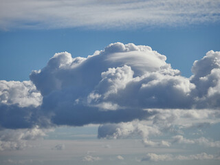 Cumulus clouds. White clouds on the blue sky close-up.