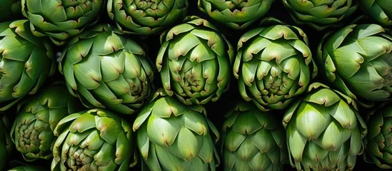 Fotobehang Numerous large artichokes available at the outdoor market © AkuAku