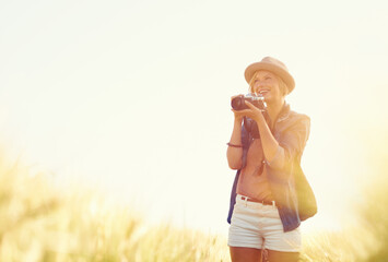 Outdoor, sunshine and woman with a camera, photographer and travelling with happiness, lens flare...