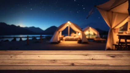Kussenhoes Wooden table top on blur tent camping travel tent at night © adynue