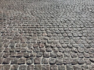 Stone block paving pavement old road.
