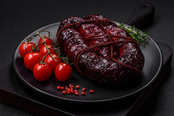 Delicious black blood sausage or black pudding with spices and herbs