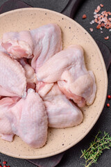 Fresh raw chicken wings with salt and spices prepared for baking