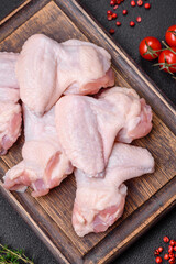 Fresh raw chicken wings with salt and spices prepared for baking