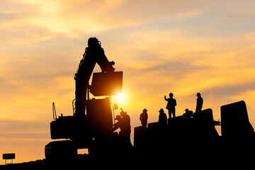 Silhouette of Engineer and worker checking project at building site, Engineer and builders in...