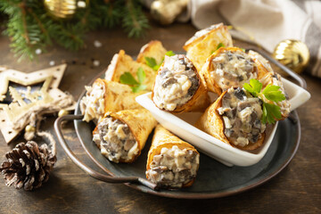 Creative appetizers christmas. Lavash roll cone with chicken and mushroom salad on a plate.