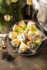 Creative appetizers christmas. Lavash roll cone with chicken and mushroom salad on a plate. Copy space.