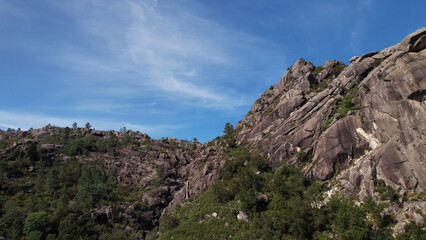 Fototapeta na wymiar High Mountains with Blue Sky and White Clouds in the Background. Natural Park of Gerês, Portugal