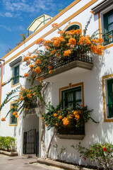 Fototapeta na wymiar Houses with flowers in the Spanish town of Puerto de Mogán