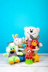 Collection of colorful toys on a blue concrete background. Kids toys.