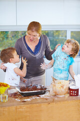 Family, baking and a mother scolding her children for the mess in a home kitchen with naughty boys....