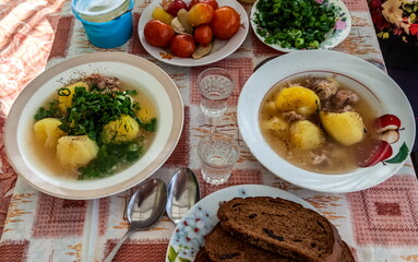 Dinner table for two with soup and snacks close-up