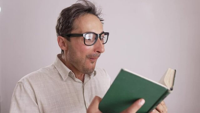 Surprised man reading a book.