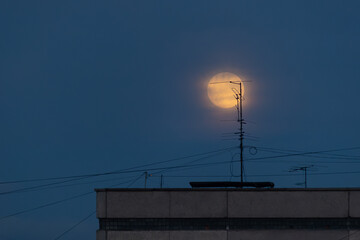 The moon is in the wires, the connection with the Moon, the Moon is in touch, The moon is on the roof of the house, full city moon