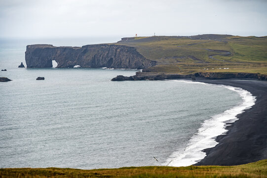 Coastline and black beach near Vik in Iceland with rock formations