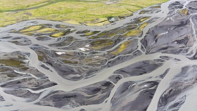 Aerial view of patterns of Icelandic rivers flowing into the ocean. Iceland Drone footage