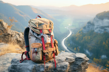 Close up of hiking backpack on stone in background of autumn mountains. Travel concept of vacation and holiday. - obrazy, fototapety, plakaty