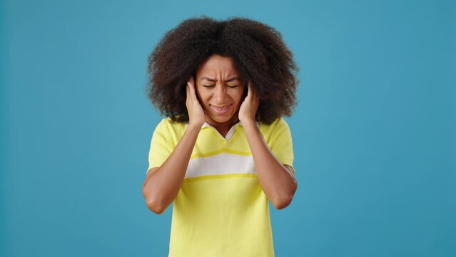 African-American lady closes ears by hands ignoring dialog