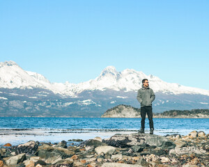 homem na beira de lago com montanhas da cordilheira dos andes cobertas de neve no Parque nacional...