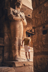 young male traveler visits Karnak temple in Luxor, Egypt	