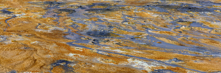 Hverir, Iceland. A surreal, bare orangy-red, geothermal area at the foot of Namafjall. Full of fumaroles, mud pools, steam vents. It's on Route 1. It is also called Namaskard Hverir.