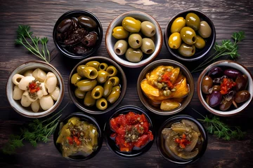 Foto op Canvas close-up of marinated olives with herbs and spices in a wooden table © Marina Varnava