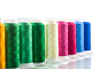set of different color sewing threads,on white background.