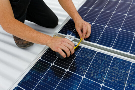 A close up photo of solar panels being installed on a corrugated roof in Worcester, Western Cape, South Africa.