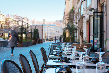 Cafe tables with tableware in the city
