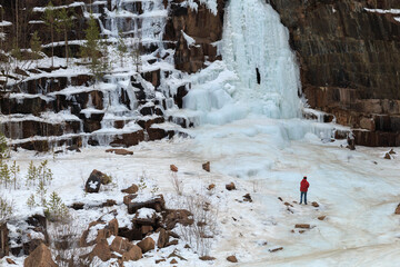 athletes - climbers train on a glacier, young climbers climb an icy rock with a safety rope
