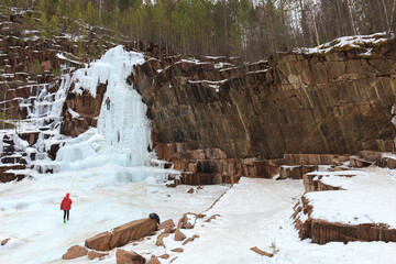 athletes - climbers train on a glacier, young climbers climb an icy rock with a safety rope