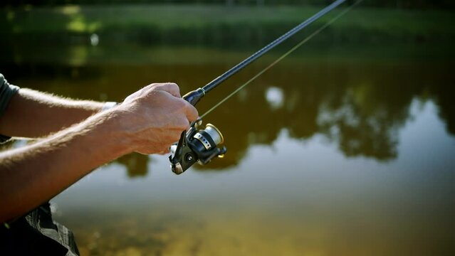 Fisherman catching fish perch on river	