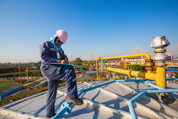 Fototapeta na wymiar Male worker inspection recording visual roof storage tank oil