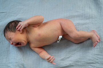 A small newborn boy is crying.Small baby 1 week old.