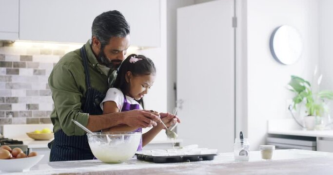 Father, daughter and happy with baking in kitchen with fun for learning, child development and bonding with play at home. Family, man and kid with apron for cooking, support and dessert with love