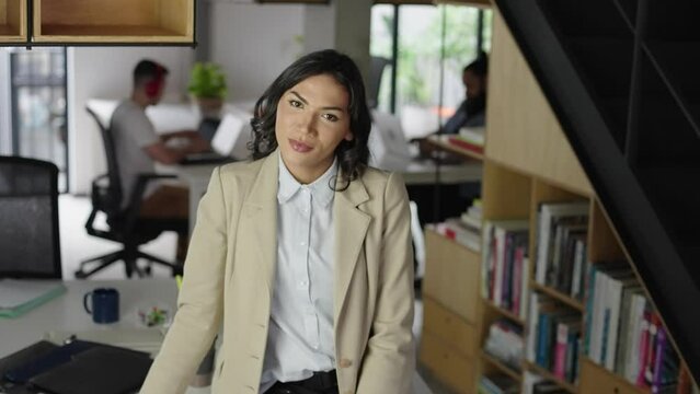 Attractive happy transgender wearing formal elegant clothes looking camera at modern office. Concept of gender expression, identity and diversity.
