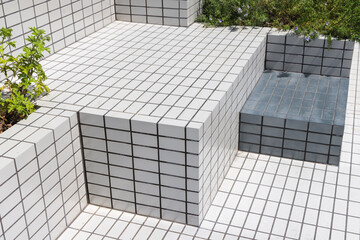 Tiled bench installation with plant decorations in public spaces