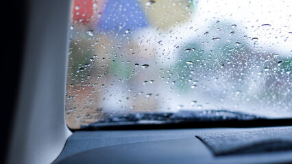 Selective focus. Rain drop on windshield. Driver slow down on the road in rainy season concept.